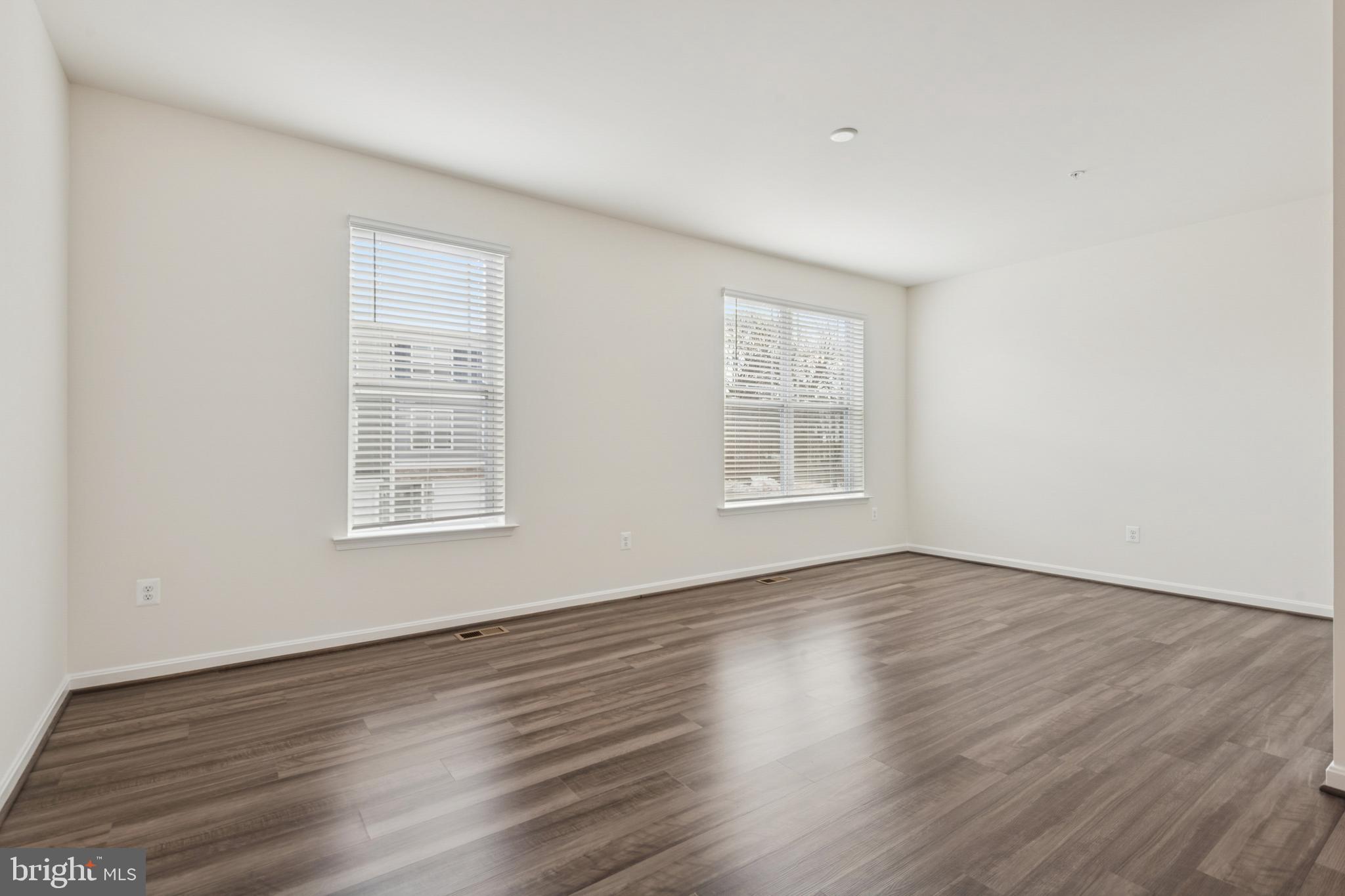 7831 Wolf Run Lane Severn, MD 21144 - Photo 14 of 30 an empty room with wooden floor and windows