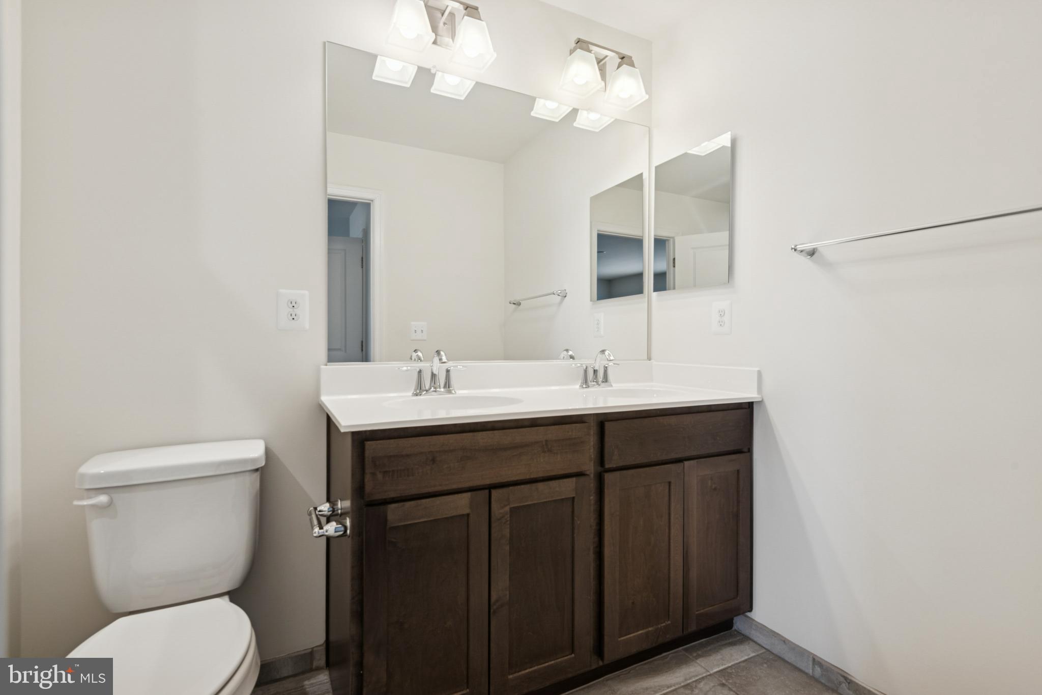 7831 Wolf Run Lane Severn, MD 21144 - Photo 17 of 30 a bathroom with a toilet a sink and mirror