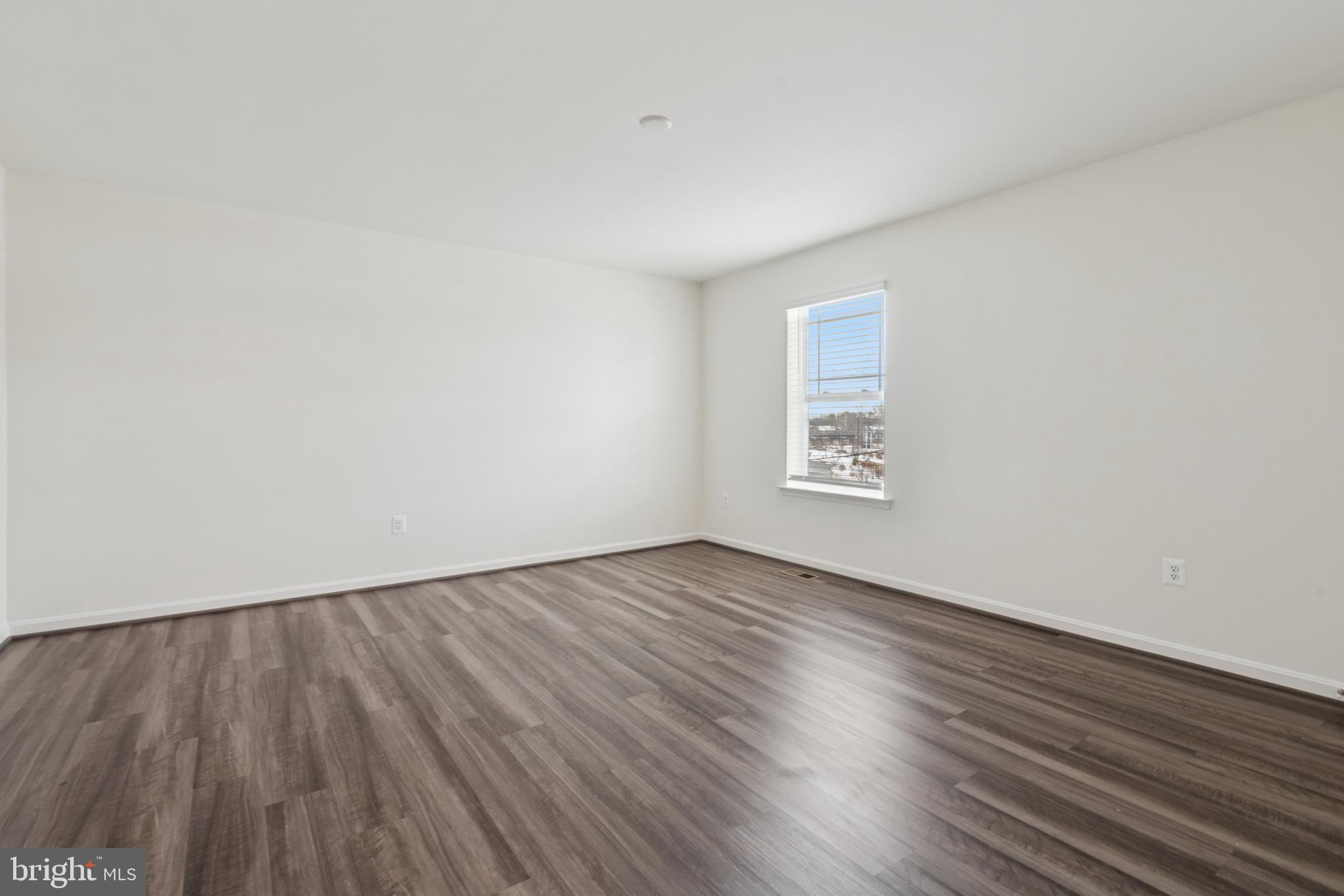 7831 Wolf Run Lane Severn, MD 21144 - Photo 21 of 30 an empty room with wooden floor and windows
