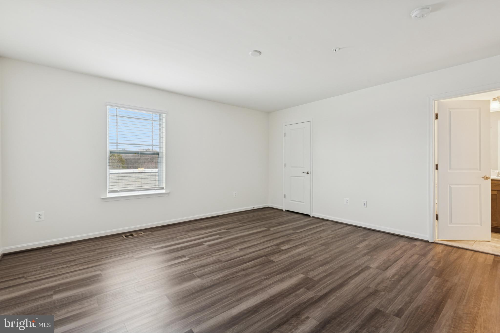 7831 Wolf Run Lane Severn, MD 21144 - Photo 22 of 30 a view of an empty room with wooden floor