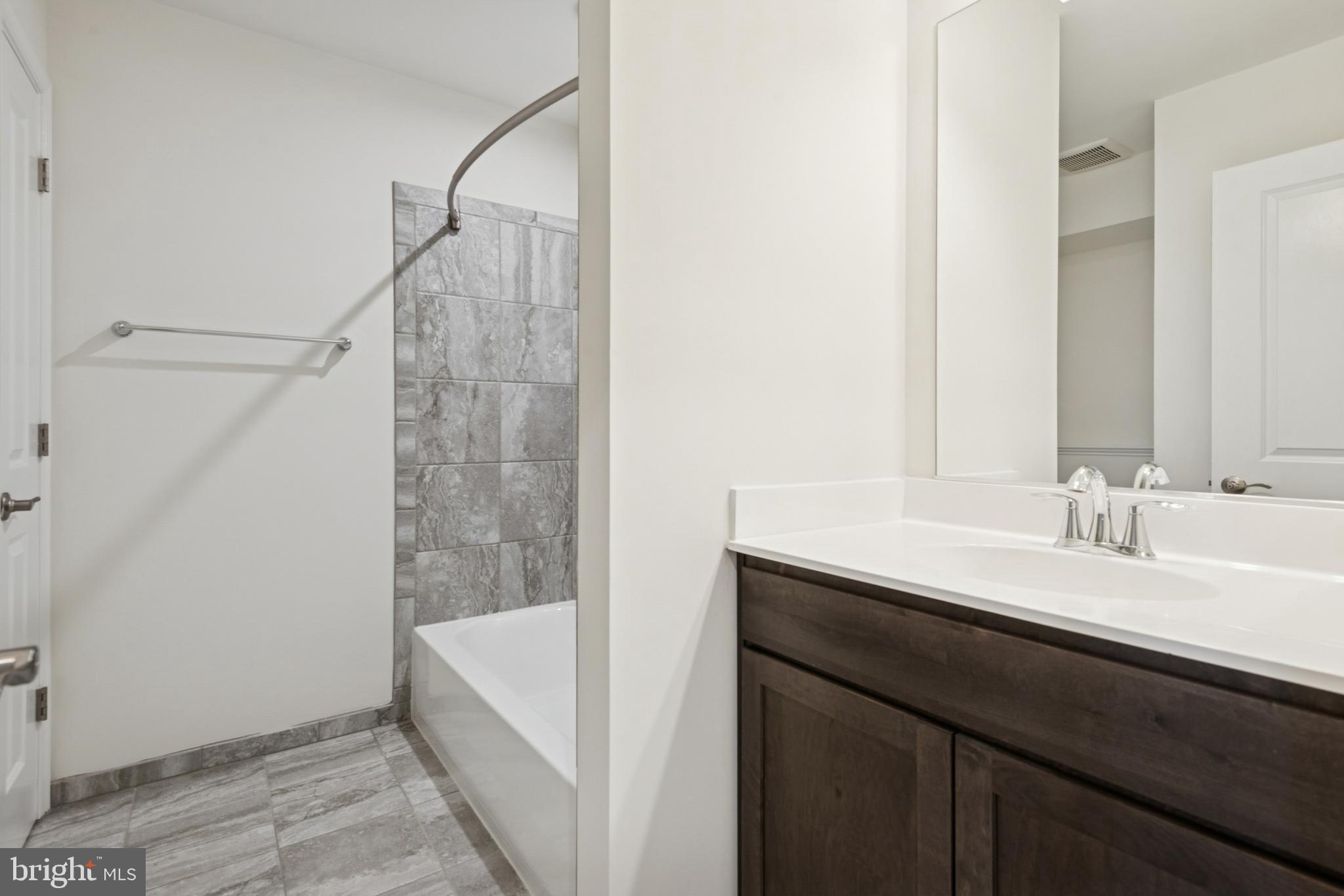 7831 Wolf Run Lane Severn, MD 21144 - Photo 23 of 30 a bathroom with a sink and a mirror