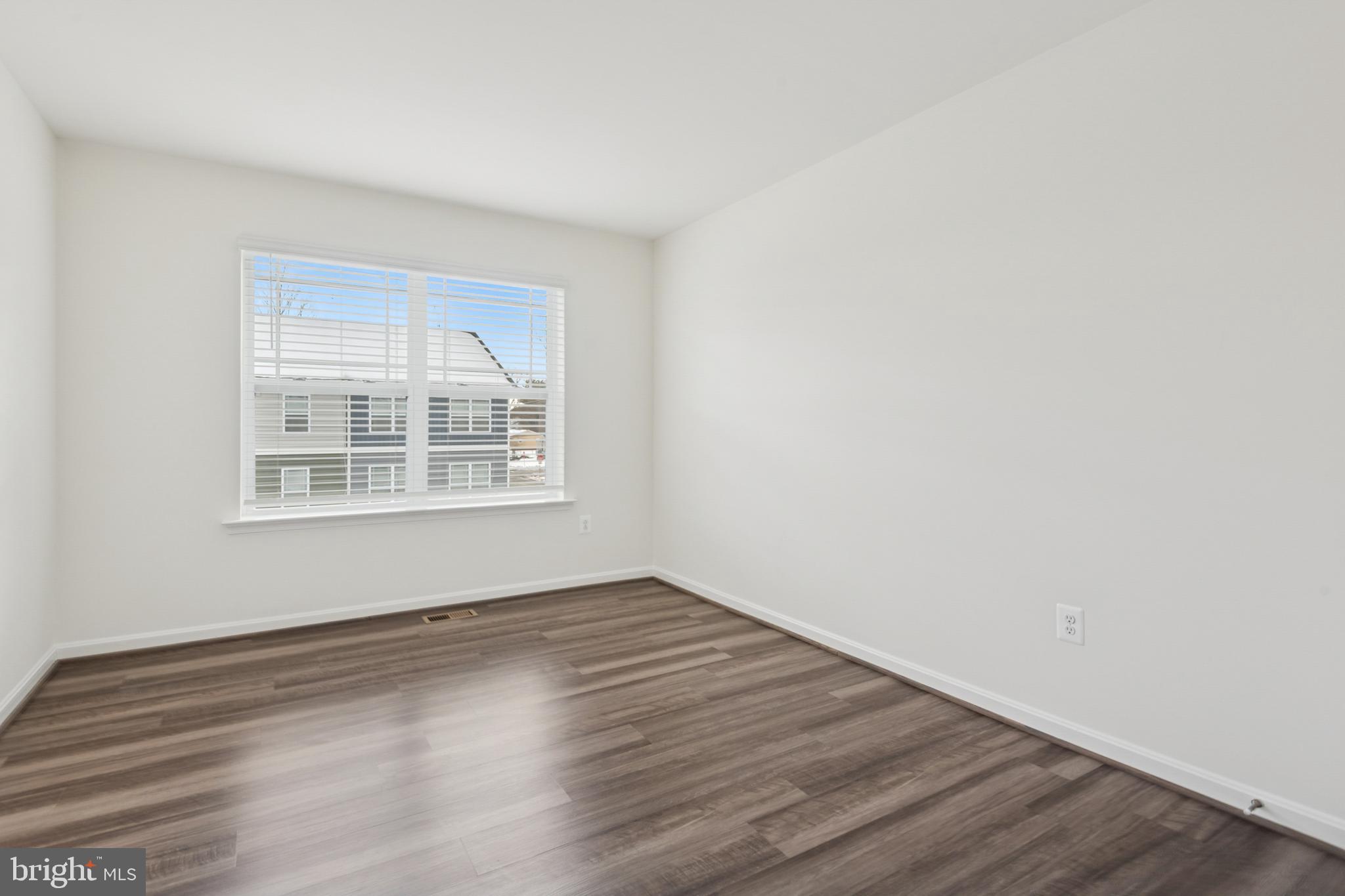 7831 Wolf Run Lane Severn, MD 21144 - Photo 26 of 30 wooden floor in an empty room with a window