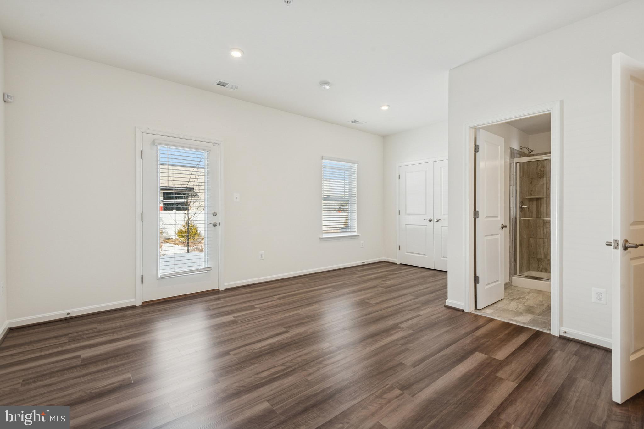 7831 Wolf Run Lane Severn, MD 21144 - Photo 30 of 30 an empty room with wooden floor & windows and bathroom