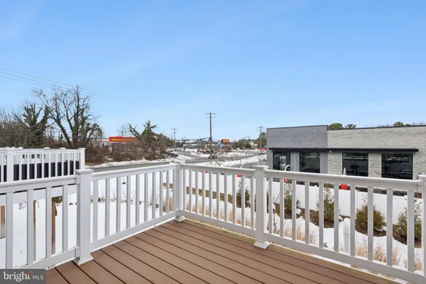 a view of a house with wooden fence