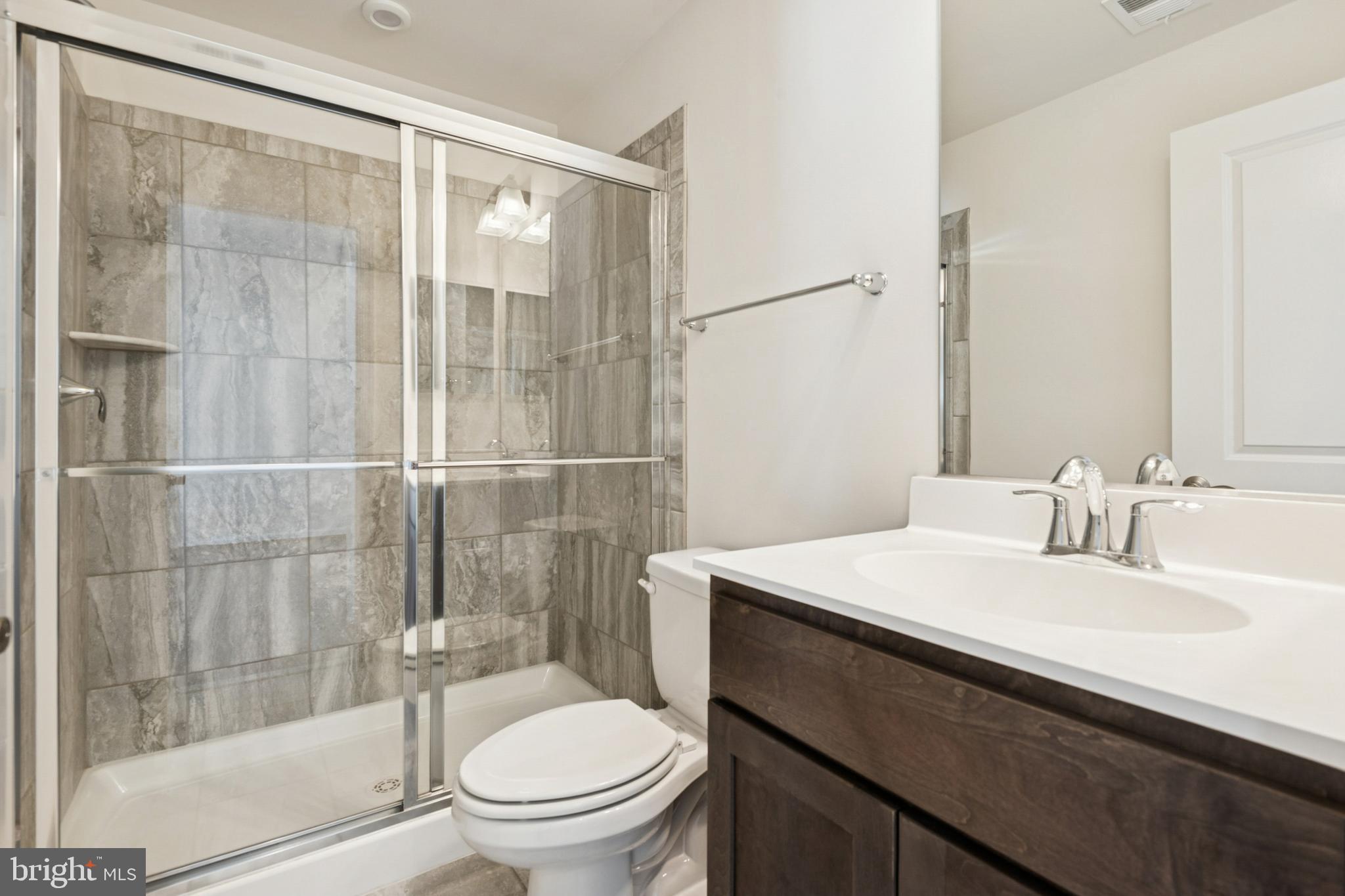 7831 Wolf Run Lane Severn, MD 21144 - Photo 9 of 30 a bathroom with a sink toilet and shower