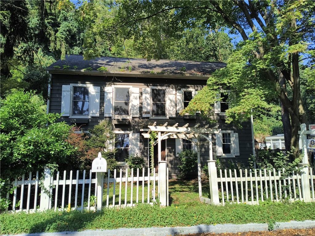a view of a house with a wooden fence