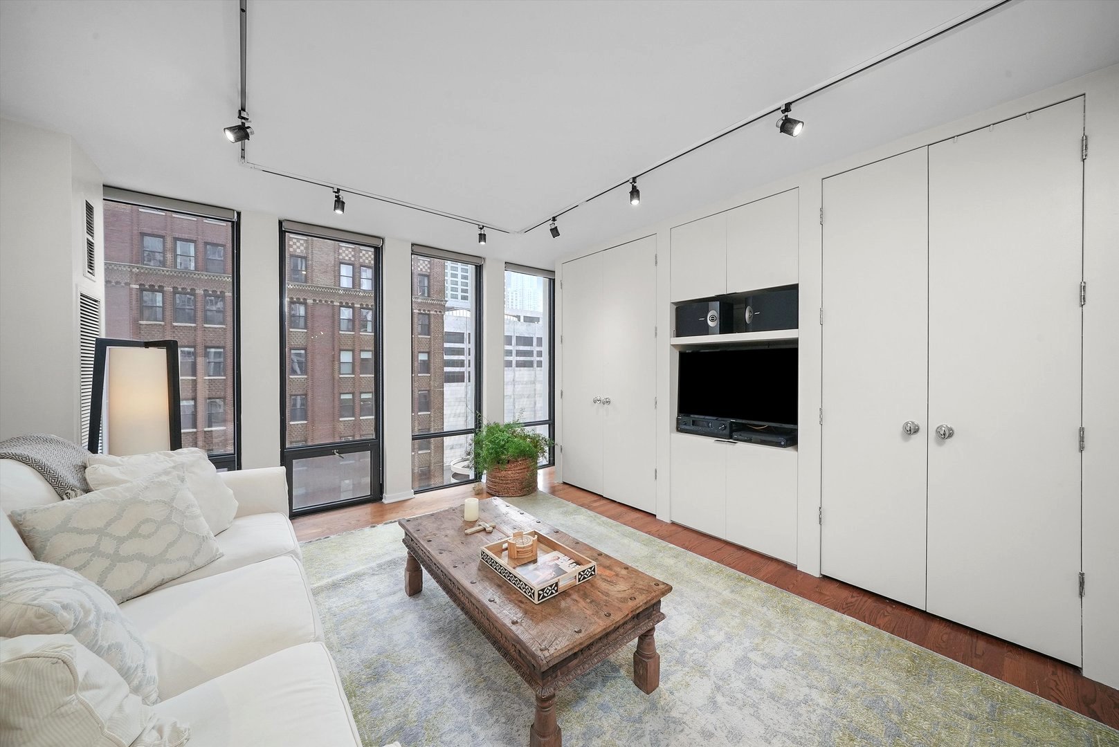 200 East Delaware Place, Unit 15F Chicago, IL 60611 - Photo 12 of 27 a living room with furniture and a flat screen tv