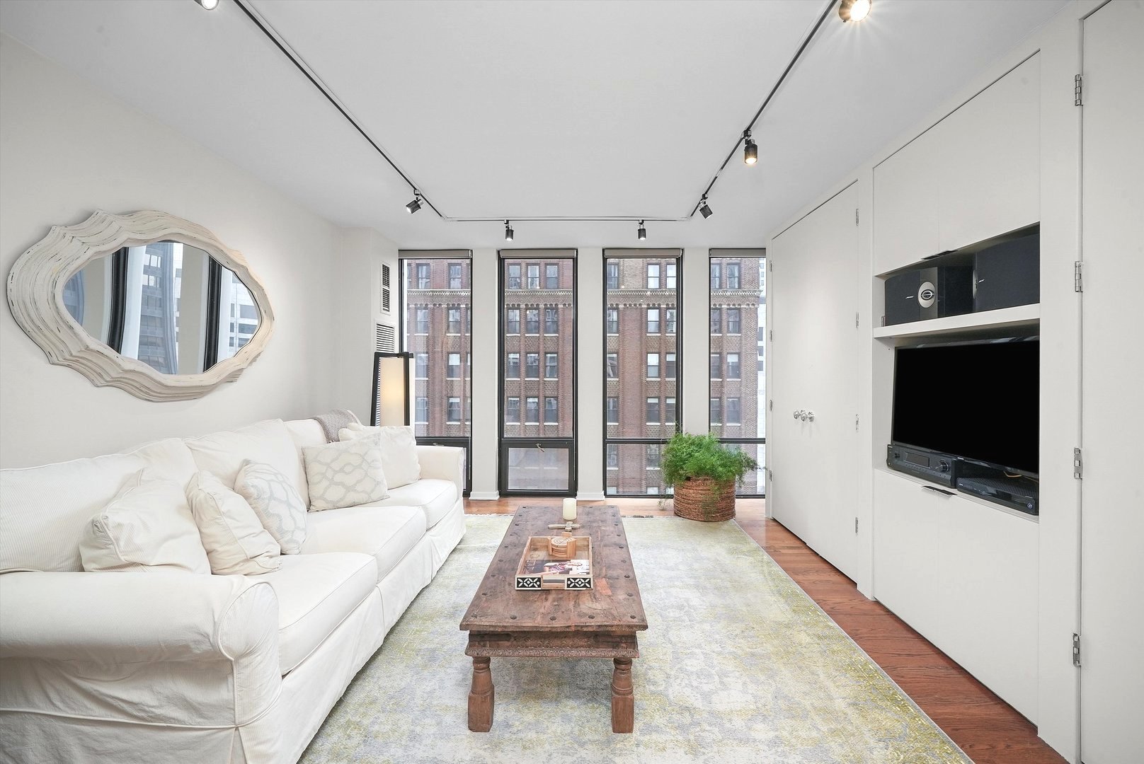 200 East Delaware Place, Unit 15F Chicago, IL 60611 - Photo 13 of 27 a living room with furniture and a flat screen tv
