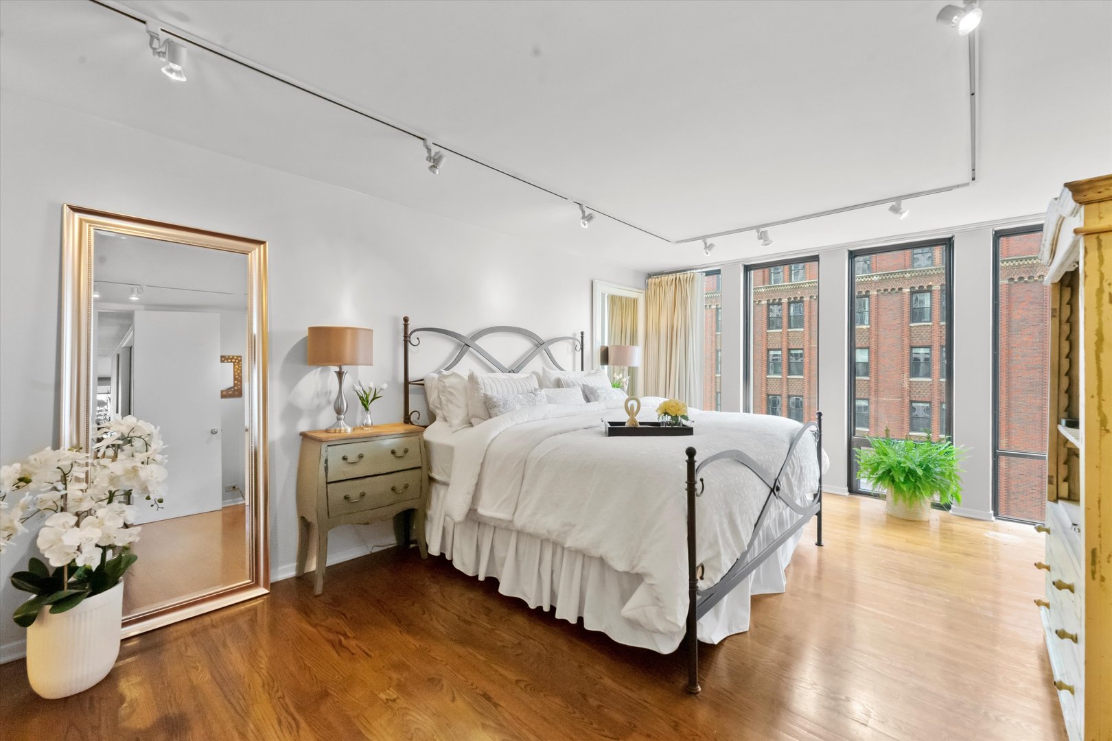 200 East Delaware Place, Unit 15F Chicago, IL 60611 - Photo 14 of 27 a bed room with a bed and a potted plant