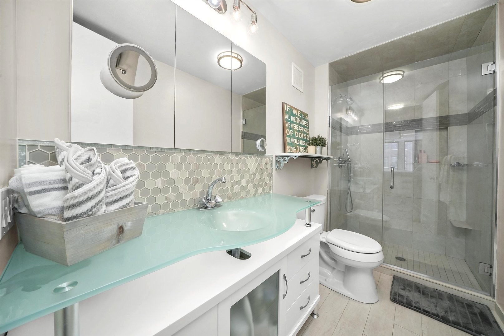 200 East Delaware Place, Unit 15F Chicago, IL 60611 - Photo 16 of 27 a bathroom with a sink a toilet and a shower