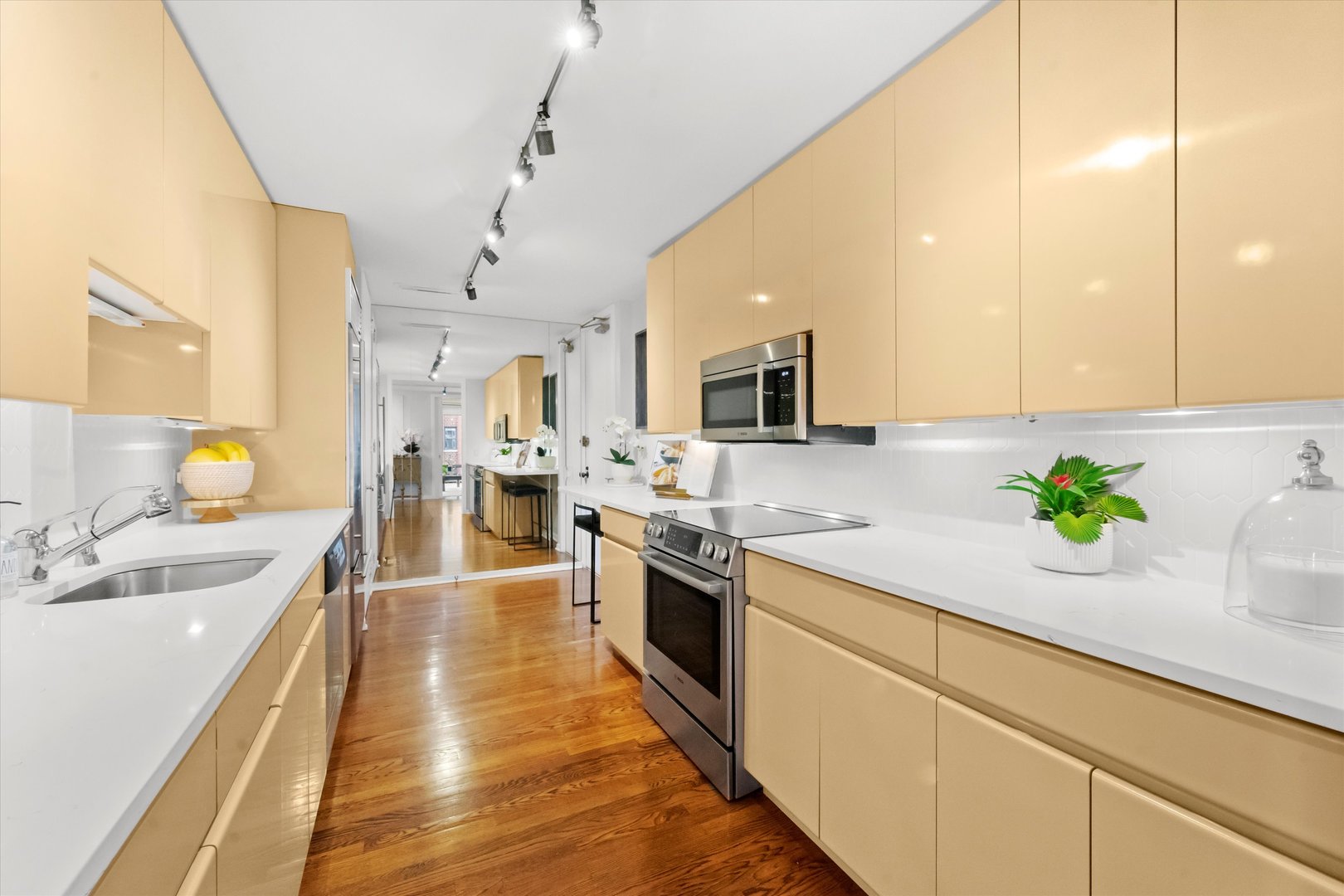 200 East Delaware Place, Unit 15F Chicago, IL 60611 - Photo 2 of 27 a large kitchen with granite countertop a sink stainless steel appliances and cabinets