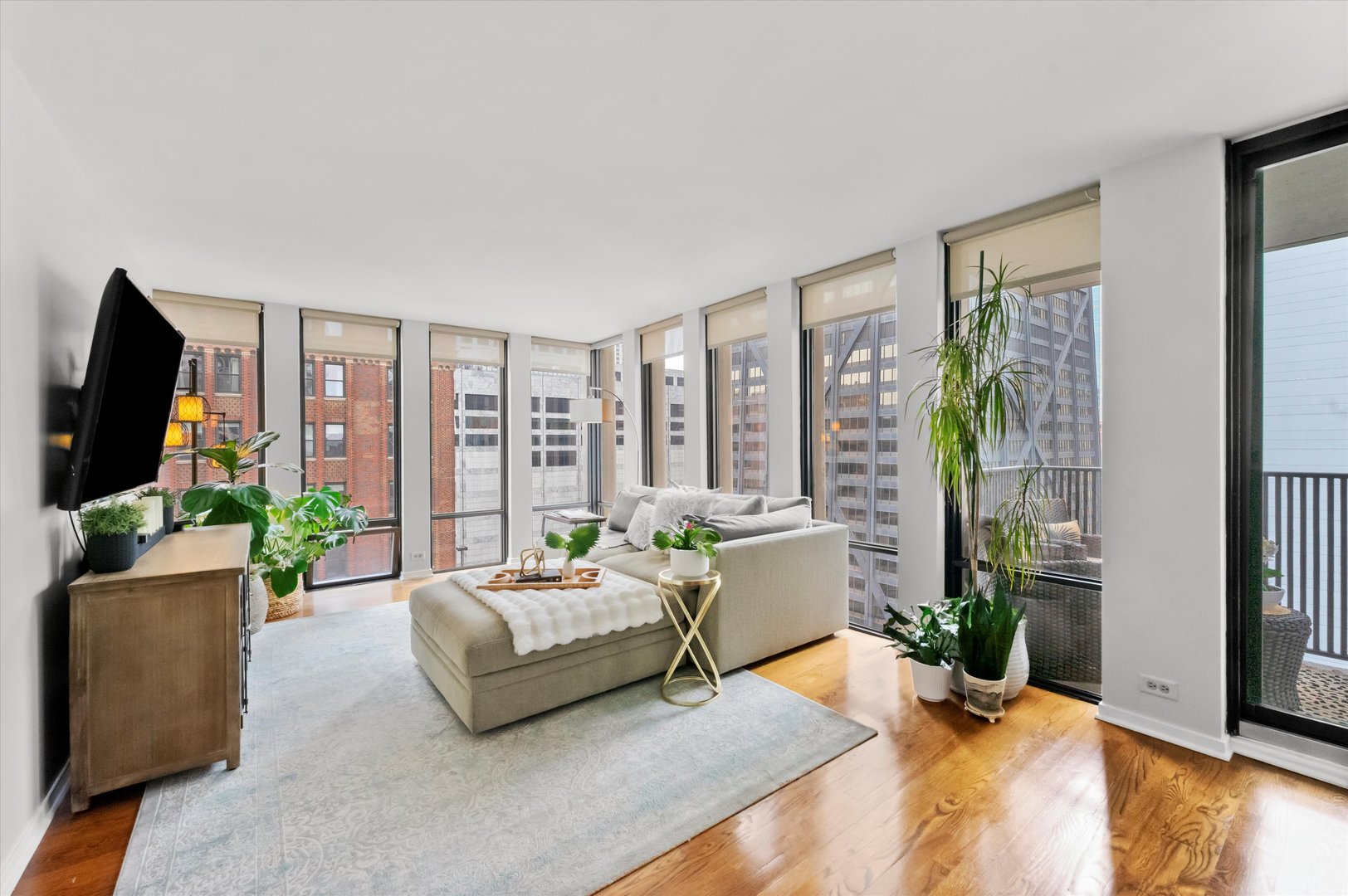200 East Delaware Place, Unit 15F Chicago, IL 60611 - Photo 6 of 27 a living room with furniture and a flat screen tv