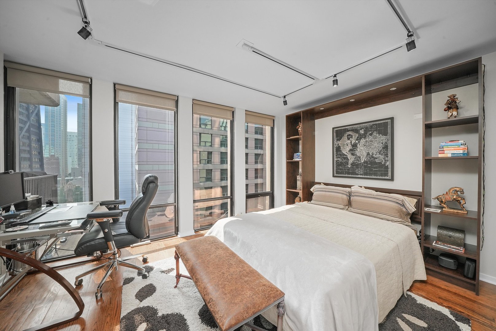 200 East Delaware Place, Unit 15F Chicago, IL 60611 - Photo 8 of 27 a bedroom with a bed large window with chair and balcony