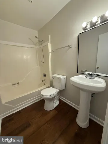 a white toilet sitting next to a bathroom sink