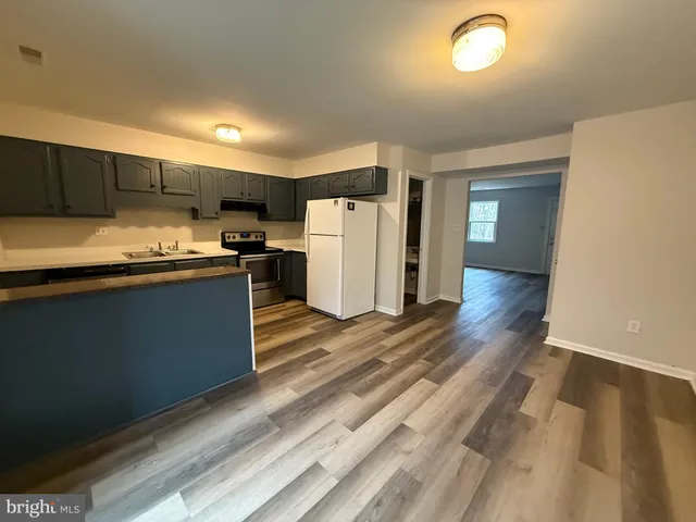 a kitchen with stainless steel appliances a refrigerator and a stove top oven