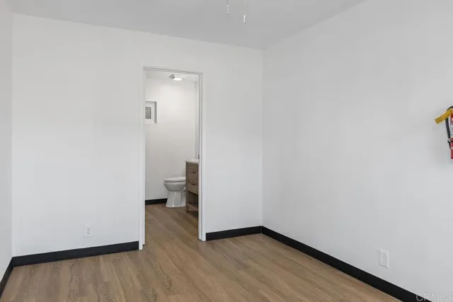 a view of an empty room and wooden floor