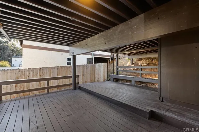 a view of a porch with wooden floor and iron stairs