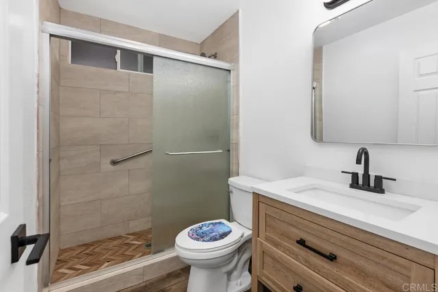 a bathroom with a sink toilet and shower