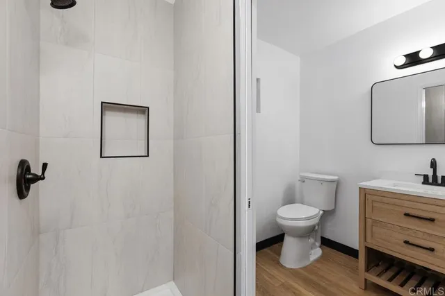 a room with a toilet sink and mirror