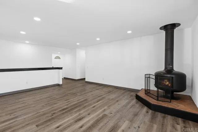a view of a room with wooden floor and a window