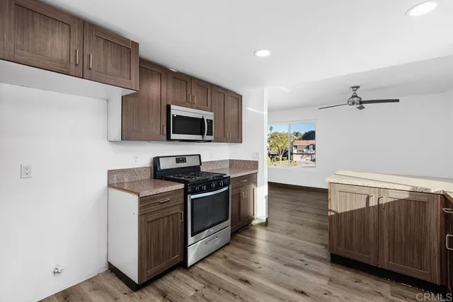 a kitchen with stainless steel appliances a stove microwave and cabinets