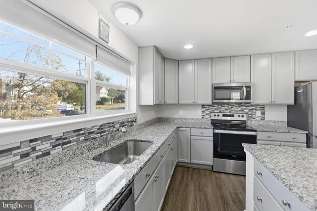 a kitchen with a stove a sink and a microwave