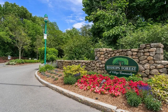 a view of sign board with flower plants
