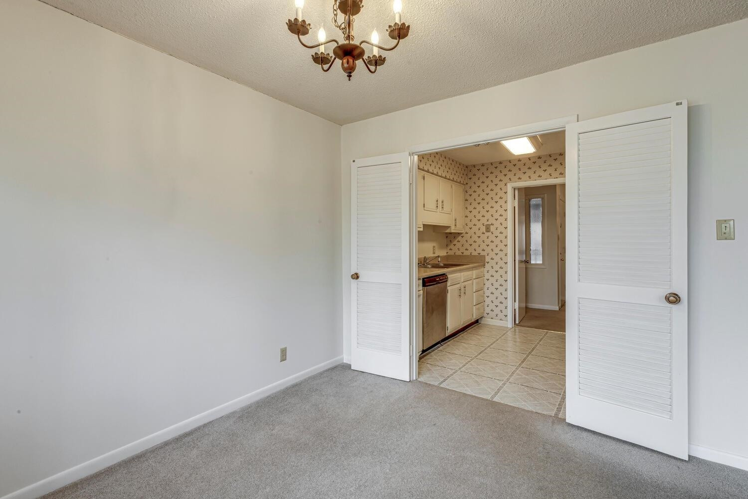 3086 Colony Road, Unit E Durham, NC 27705 - Photo 8 of 30 a view of a kitchen with a sink and a refrigerator