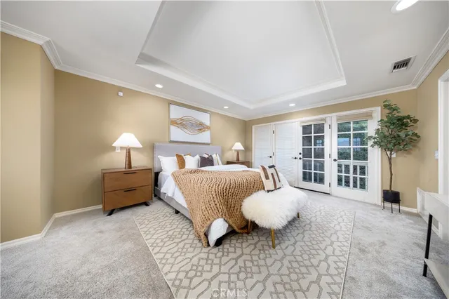 a spacious bedroom with a bed and glass window