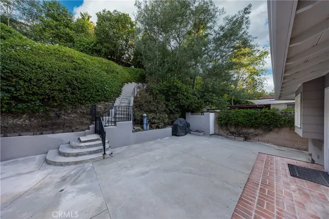 a view of a patio with a table and chairs