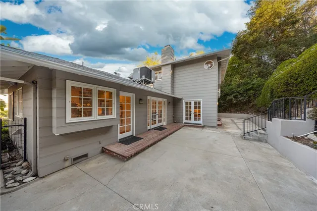 a view of house with backyard and sitting area