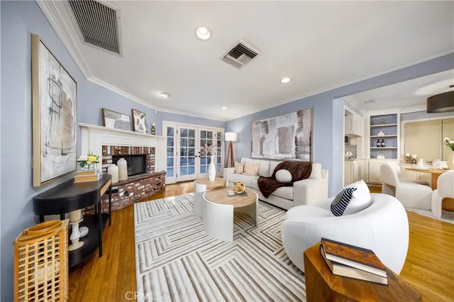 a living room with fireplace furniture and a rug