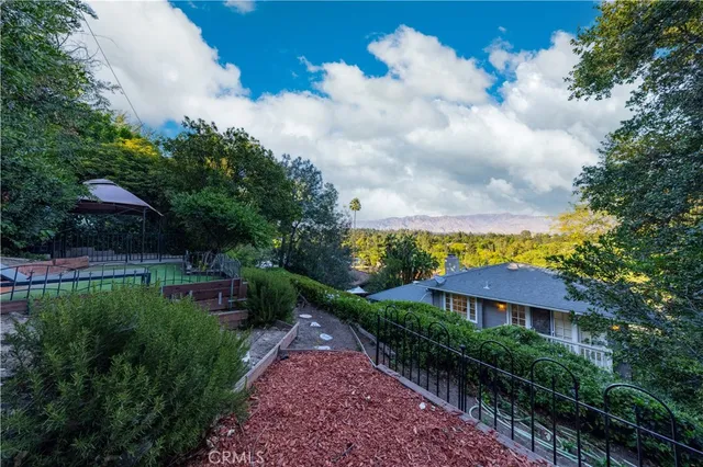 a view of a garden with a building in the background