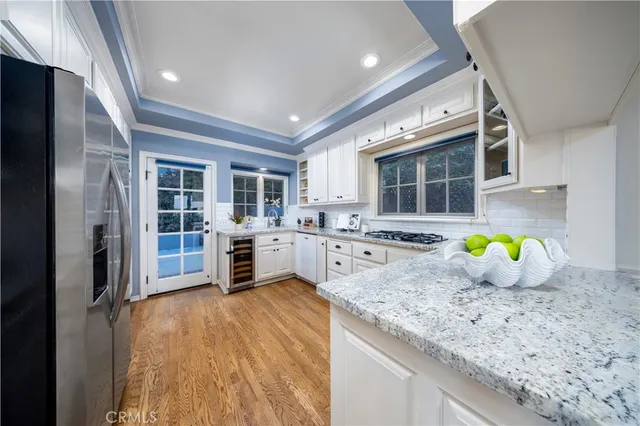 a kitchen with stainless steel appliances granite countertop a stove a sink and a refrigerator
