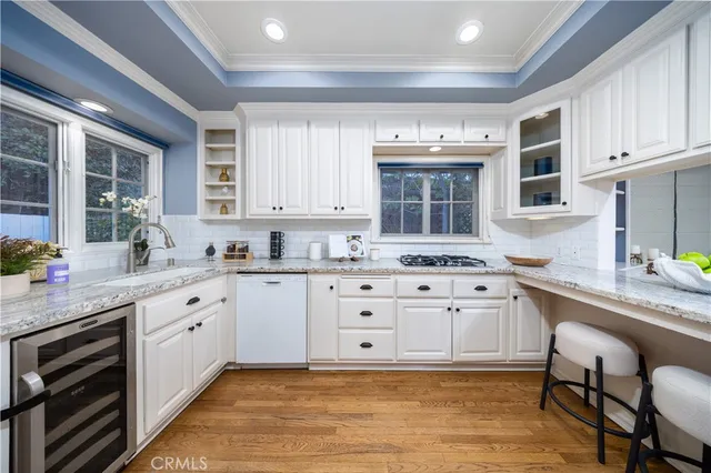 a kitchen with stainless steel appliances granite countertop a sink and cabinets