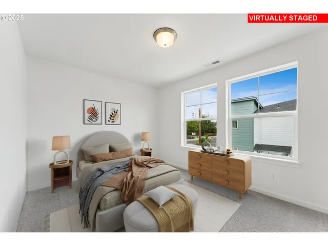 a bedroom with a bed and a large window