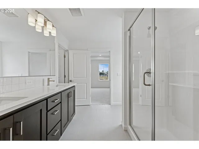 a bathroom with a granite countertop sink a mirror and a shower