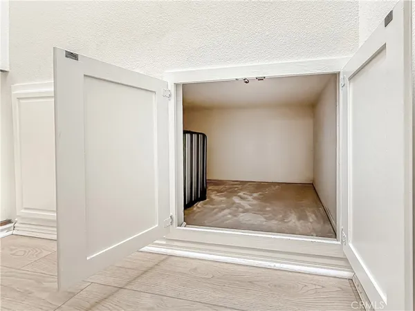 a view of an empty room and wooden floor