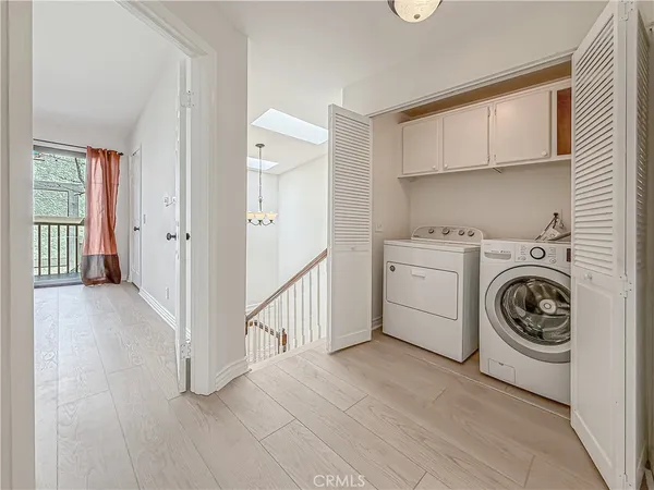 a spacious bedroom with a bed couch and a window
