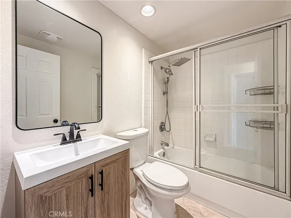 a view of a swimming pool with a patio and a yard