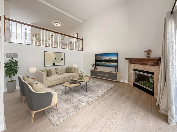 a living room with furniture a fireplace and a flat screen tv
