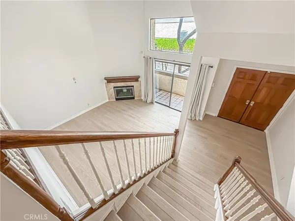 a view of a hallway with wooden floor and furniture