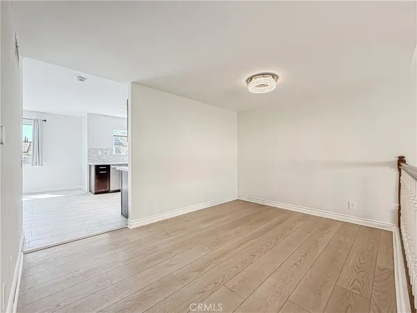 a dining room with furniture and a wooden floor