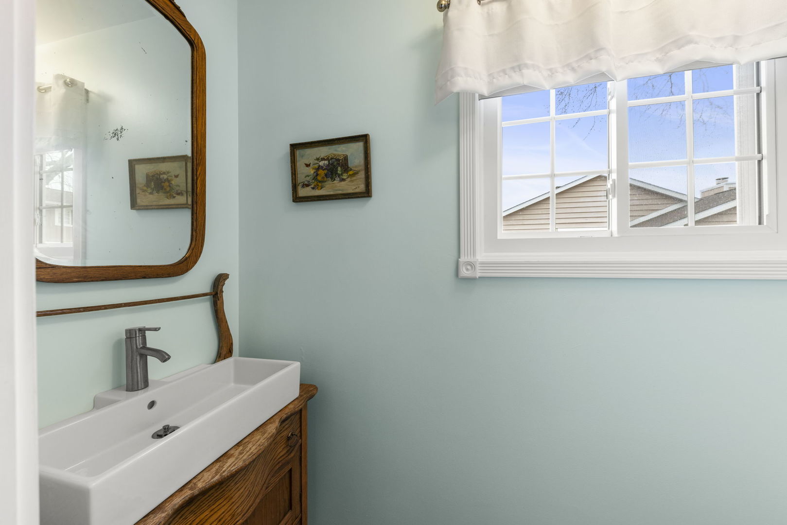 1263 Exeter Court Wheaton, IL 60189 - Photo 12 of 25 a bathroom with a sink and a mirror