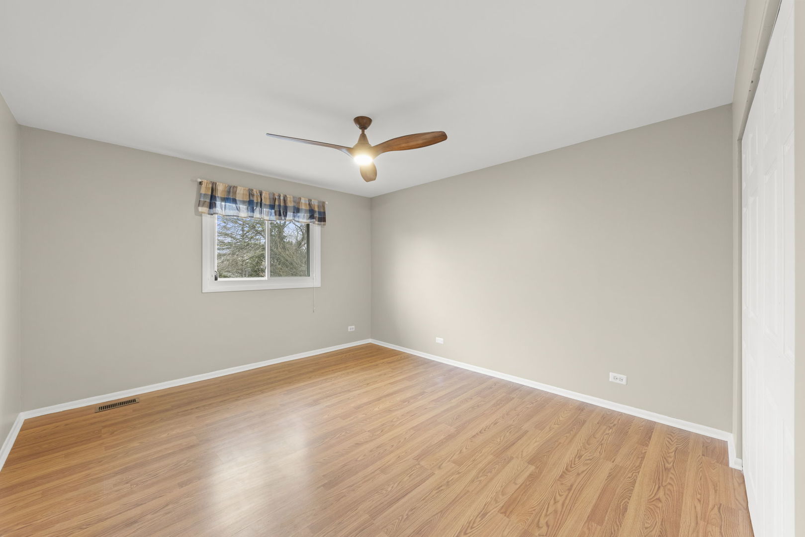 1263 Exeter Court Wheaton, IL 60189 - Photo 15 of 25 a view of a room with wooden floor and white walls