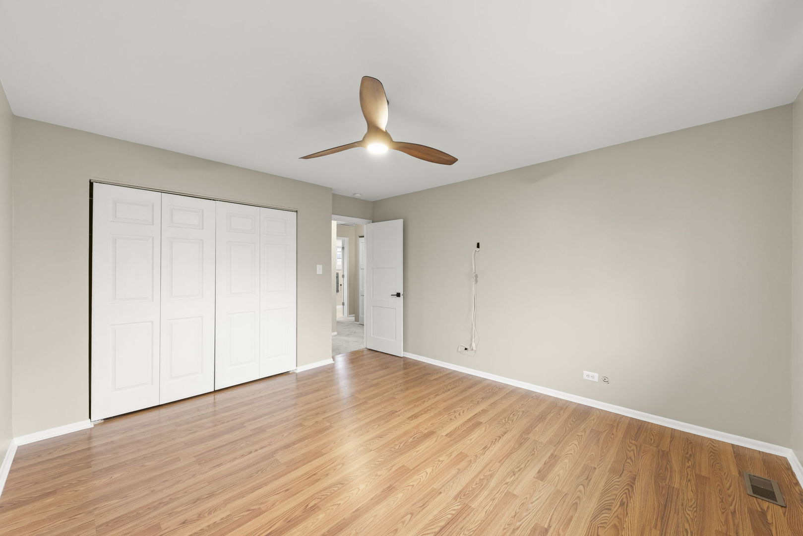1263 Exeter Court Wheaton, IL 60189 - Photo 16 of 25 a view of an empty room with wooden floor