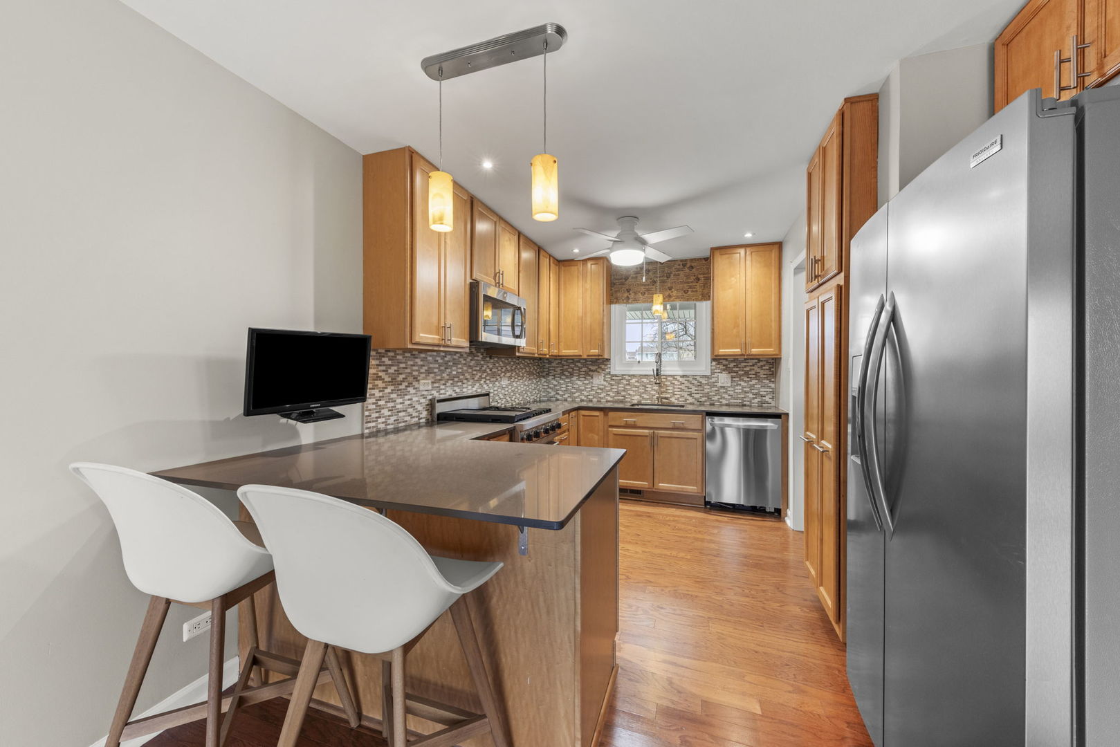 1263 Exeter Court Wheaton, IL 60189 - Photo 6 of 25 a kitchen with stainless steel appliances granite countertop a microwave a stove a sink a refrigerator and island