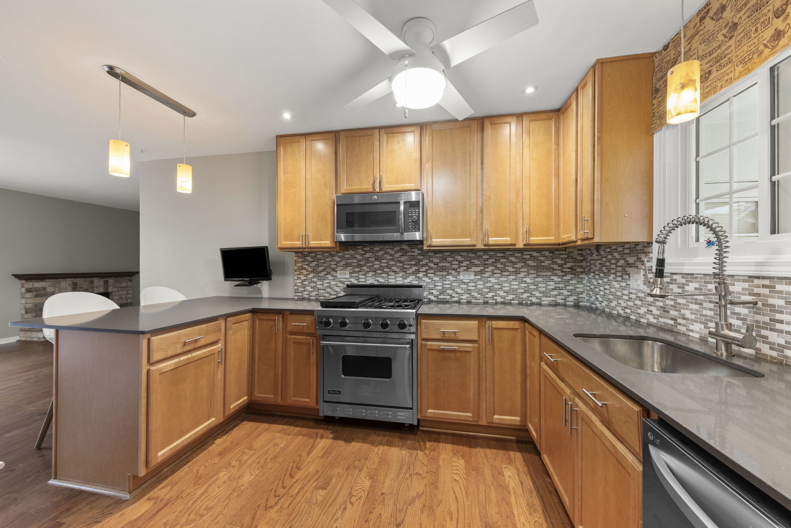 1263 Exeter Court Wheaton, IL 60189 - Photo 7 of 25 a kitchen with stainless steel appliances granite countertop a sink a stove and cabinets