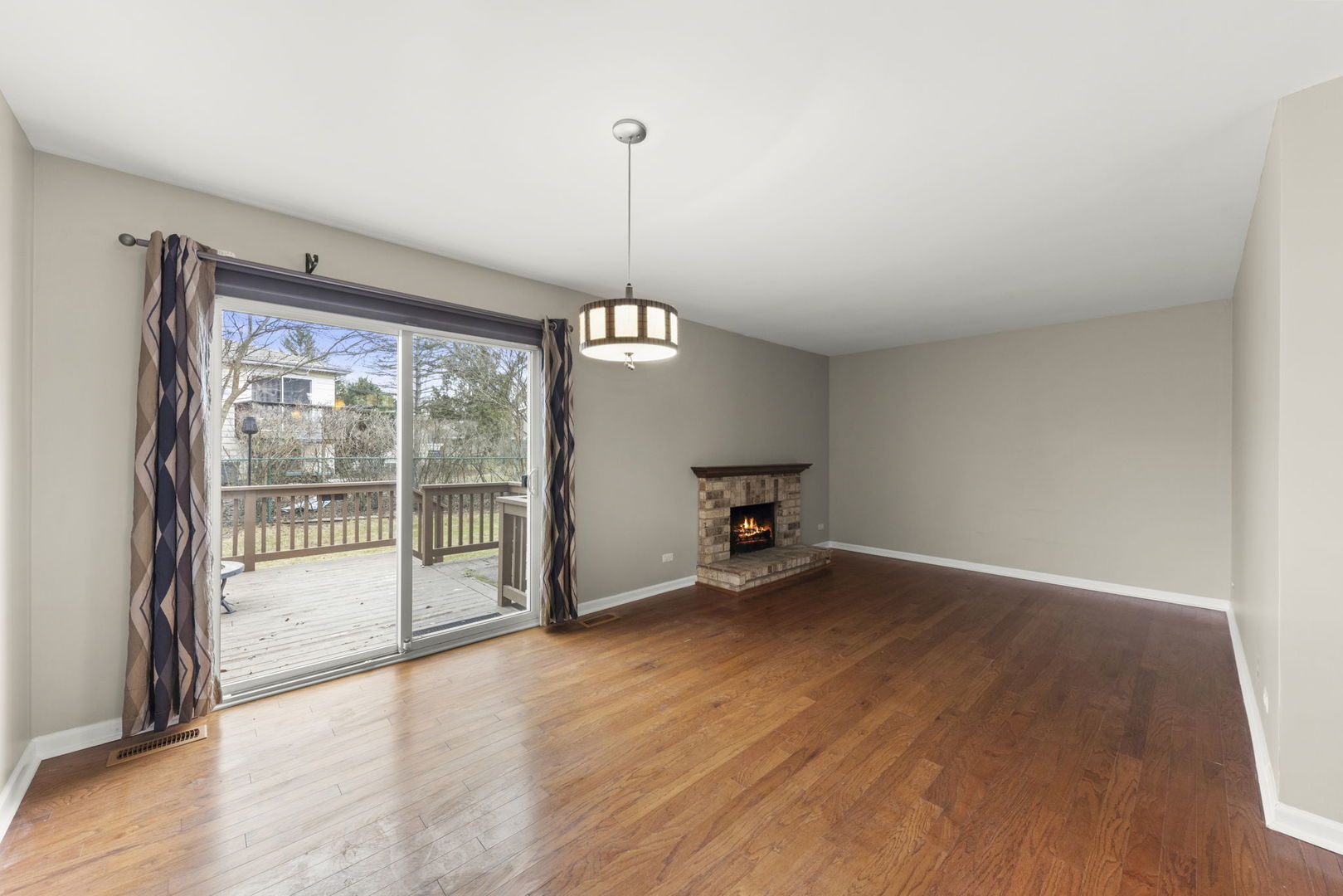 1263 Exeter Court Wheaton, IL 60189 - Photo 9 of 25 a view of an empty room with wooden floor and a window