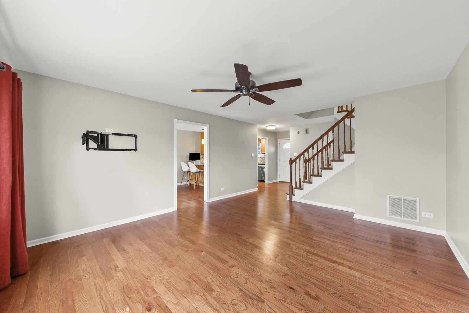 1263 Exeter Court Wheaton, IL 60189 - Photo 10 of 25 a view of an empty room with wooden floor and a ceiling fan